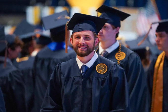 Noah Johnson walks into Commencement