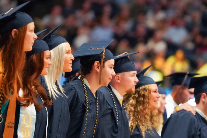Jarret Birch sings Country Roads during Commencement