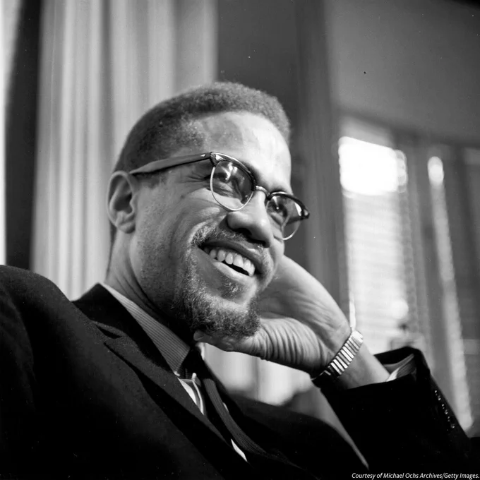 A black-and-white photograph of former Nation Of Islam leader and civil rights activist El-Hajj Malik El-Shabazz (aka Malcolm X and Malcolm Little) as he poses for a portrait on February 16, 1965, in Rochester, New York. 