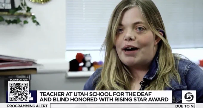 a screen shot of a woman on channel 5 with a QR code in the bottom left corner and a lower third titled "teacher at utah school for the deaf and the blind honored with rising star award"