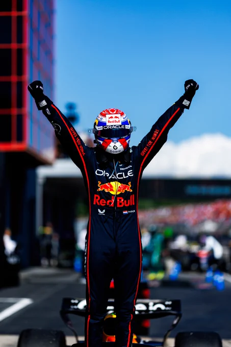 Max raises both arms in celebration after winning the 2025 Imola GP.