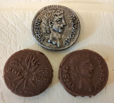 Picture showing a 3D printed coin and some chocolate coins of Augustus