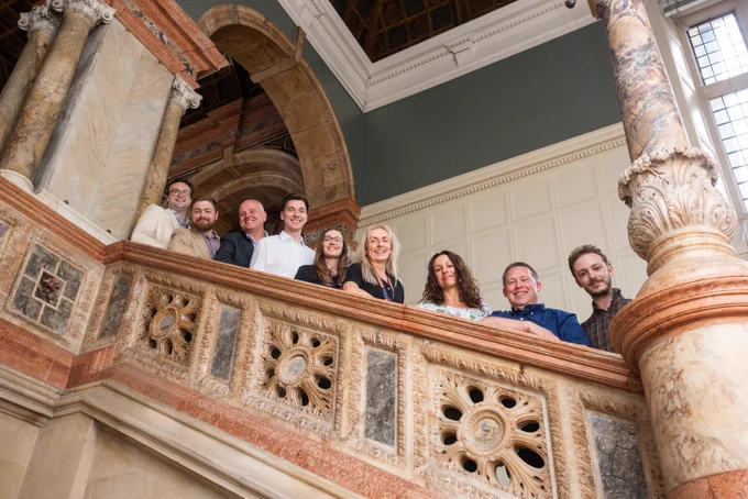 Photograph (c) John Cairns @johncairnsphotography 

The first-year lab course team on a staircase in the Exam Schools at Oxford.
