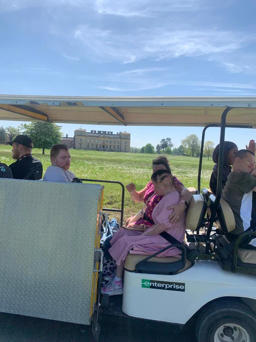 A buggy of people being driven around the estate of Croome Abbey National Trust. 