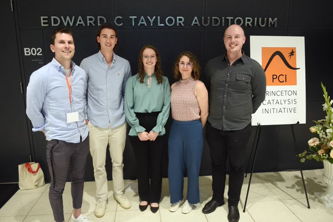 Full-color image of researchers standing at the entrance of Princeton Chemistry's Taylor Auditorium. 