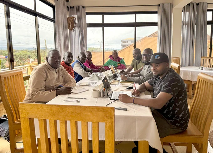 Maasai representatives and local researchers in a working session co-defining research goals and frameworks for shared stewardship and community benefit
