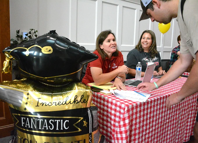 person signing something at a table