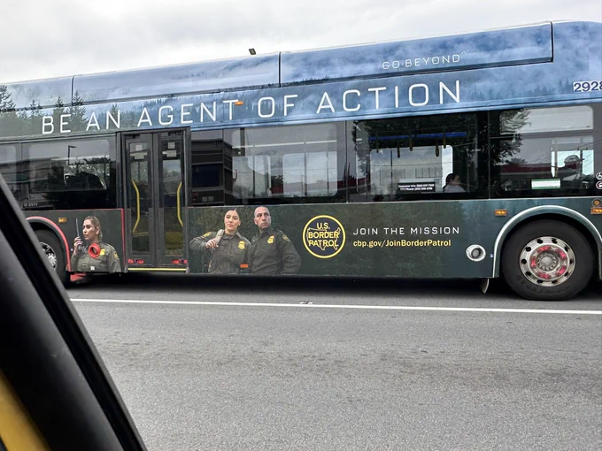 A Metro bus is clad in a wrap for the US Border patrol, begging people to be an “agent of action “