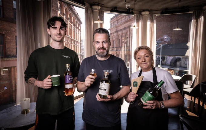 Daniel McGibbon of Neighbourhood cafe, Paul Kane of Belfast Whiskey Week, Diane Tweedy from the Poke Club at the Watson photographed holding different types of whiskey on the first floor of the new Watson Bar 