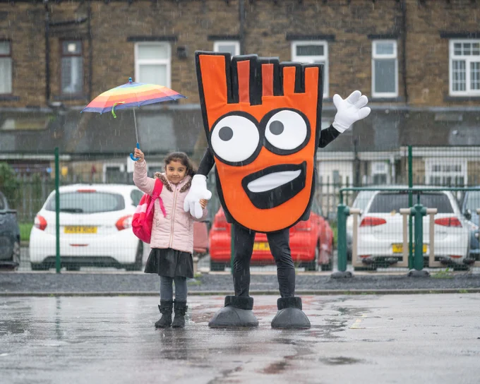 picture of girl with umbrella and Living Streets mascot