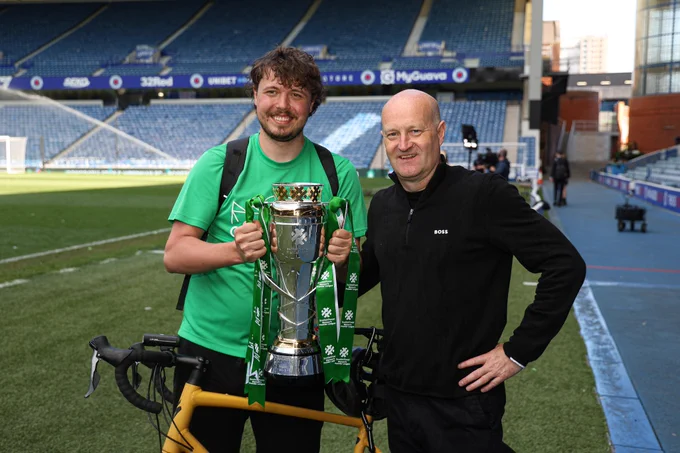 Cameron Coull and Hibs Women head coach Grant Scott with the SWPL trophy at Ibrox.