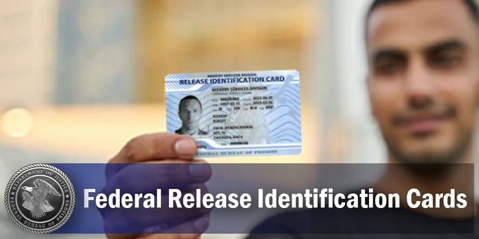 Person holding a Federal Release Identification Card, with the card in focus and the individual slightly blurred in the background.