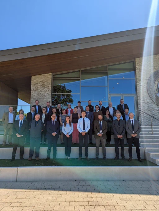 28 people, in three rows, on the steps of the NFU Scotland Pavillion at Ingliston 