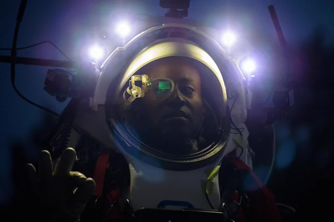 NASA astronaut Andre Douglas wears AR (Augmented Reality) display technology during a nighttime advanced technology run in the San Francisco Volcanic Field in Northern Arizona on May 21, 2024. The monocular lens consists of a pico-projector and waveguide optical element to focus an image for crew to see their real world overlaid with digital information. Credit: NASA/Josh Valcarcel