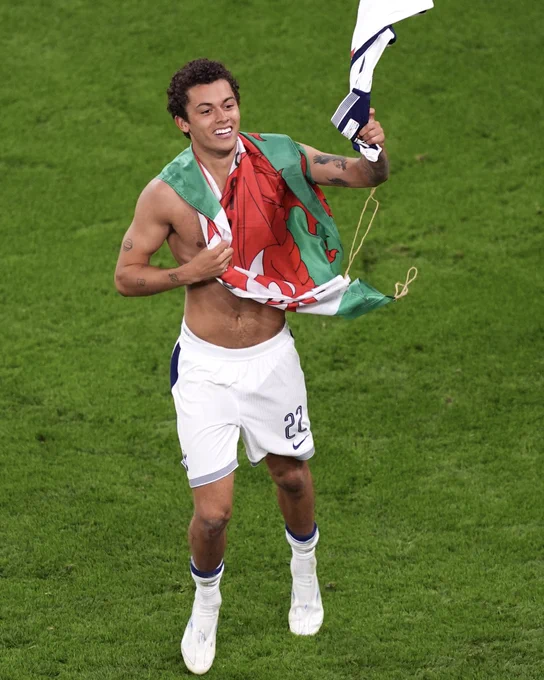 Brennan Johnson with a Cymru flag after winning the UEFA Europa League with Tottenham Hotspur.