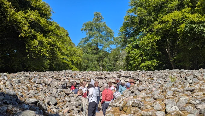 Participants of the Culloden Rock Art workshop inside a cairn at the Clava Cairns © ScARF