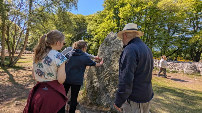 Participants of the Culloden Rock Art workshop exploring the rock art found at the Clava Cairns © ScARF