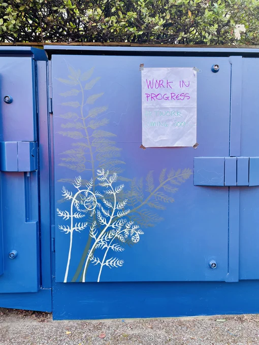 Work in Progress’ poster on junction box at 284 Iffley Road painted dark blue with fern pattern by Liz Hart