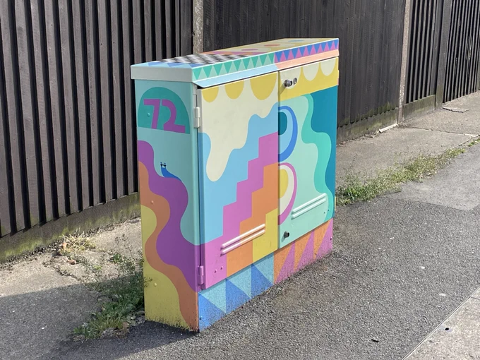 Finished painting on junction box at Boundary Brook Road with geometric designs in several colours and the number ‘72’