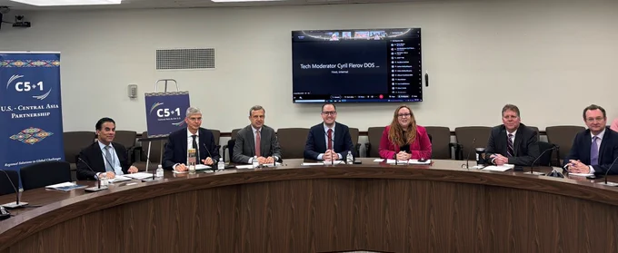 C5 1 Banner on the left.  Seven people seated at the table with screen showing virtual attendees behind them. Second and third from the left: Deputy Assistant Secretary for Central Asia John Mark Pommersheim and Senior Bureau Official for the Bureau of South and Central Asian Affairs Eric Meyer respectively. 