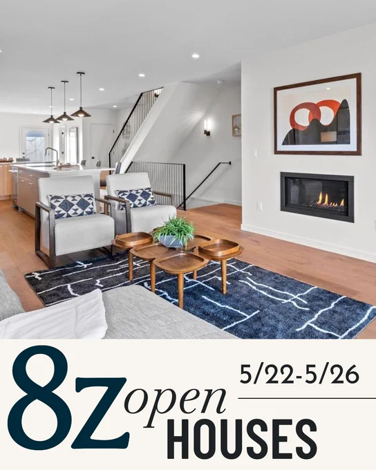 Promotional image advertising open houses from May 22 to May 26 for 8z Real Estate. Features a modern living room with a kitchen in the background, a staircase on the left, a fireplace, and stylish furnishings including a sofa, armchairs, and a round coffee table.