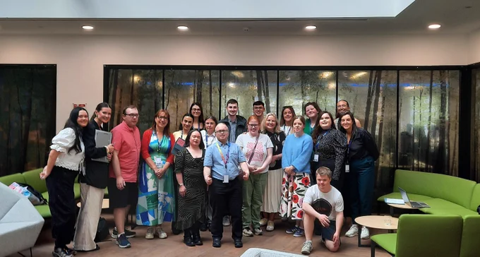 A group of TCPID students and staff standing with colleagues from Cpl