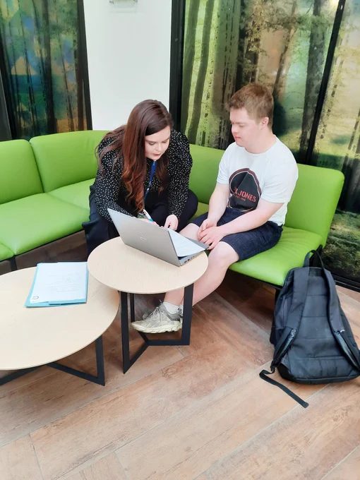 A mentor from Cpl working on a computer with a student from TCPID