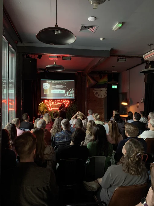 A photo from the back of the event showing the audience listening to the opening of the first night of the Pint of Science Festival in Cardiff.