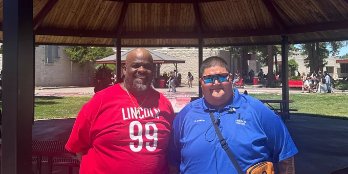 Campus supervisors Ernest Butler and Kai Garcia pose for a photo under the Lincoln High School gazebo.