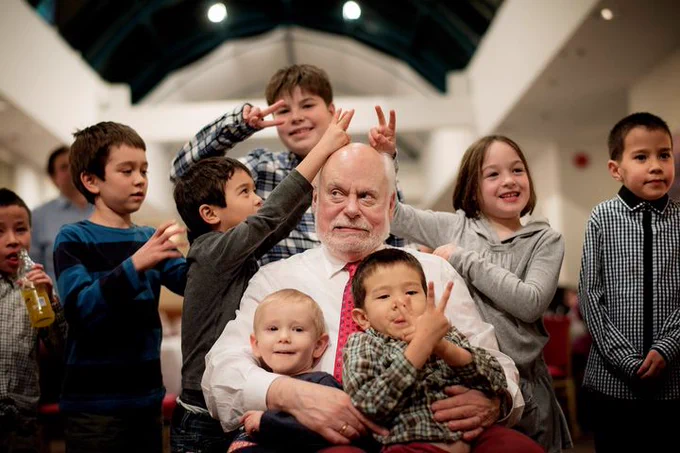 Fraser Stoddart in a playful moment with his grandchildren on his lap and gathered around him.