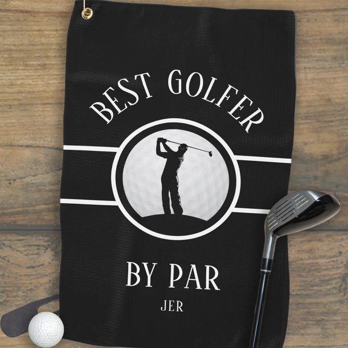 Black golf towel featuring a male golfer silhouette on a realistic golf ball with bold 'Best Golfer By Par' text in stylish white font. Includes customizable monogram space for initials or name. All colors in this design may be customized.