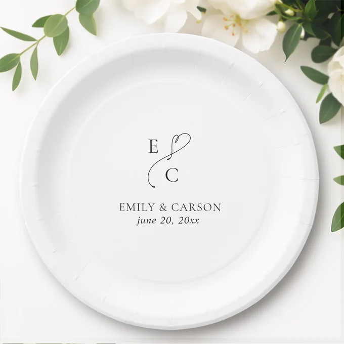 Black and white wedding paper plate featuring a custom monogram with couple’s initials, first names, and wedding date in elegant calligraphy script. A sophisticated and timeless design perfect for receptions and bridal events.