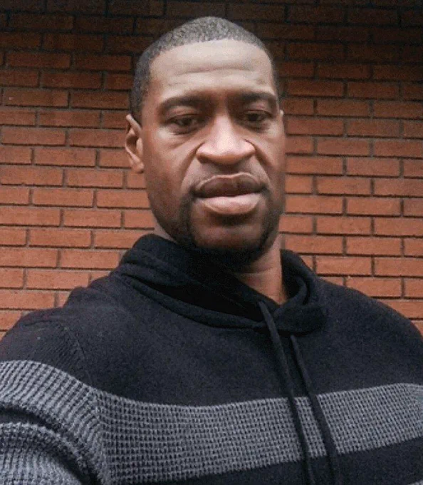 Headshot of George Floyd in front of a brick wall 