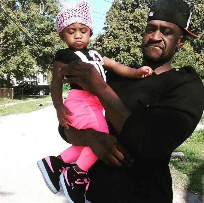 A photo of George Floyd and his young daughter in his arms