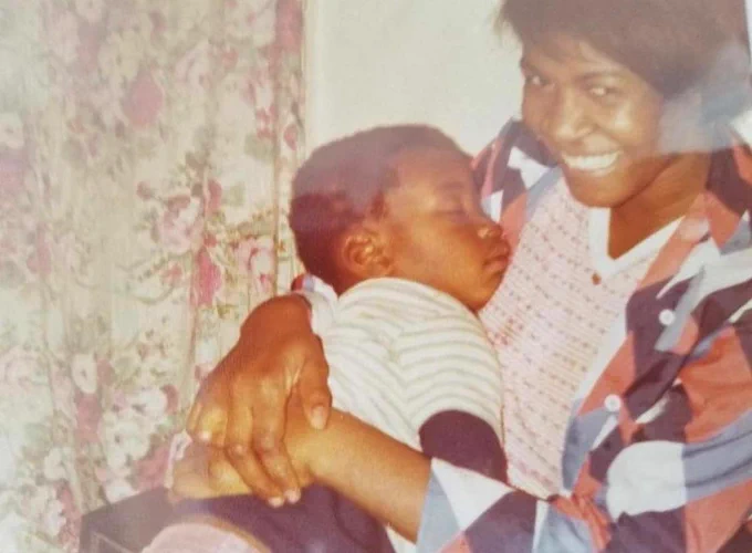 An infant George Floyd sleeps in his mother's arms