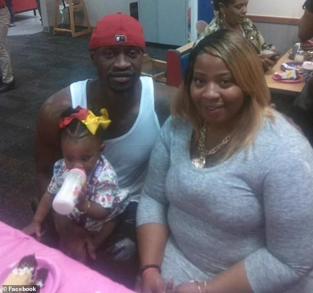 George Floyd and his fiancée take photo with their infant daughter.