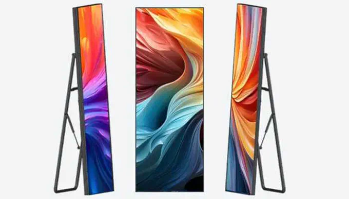 Three sleek LED Poster displays shown from front and side angles, each mounted on a minimalist black easel stand and featuring vibrant, swirling abstract colors across tall, narrow screens.