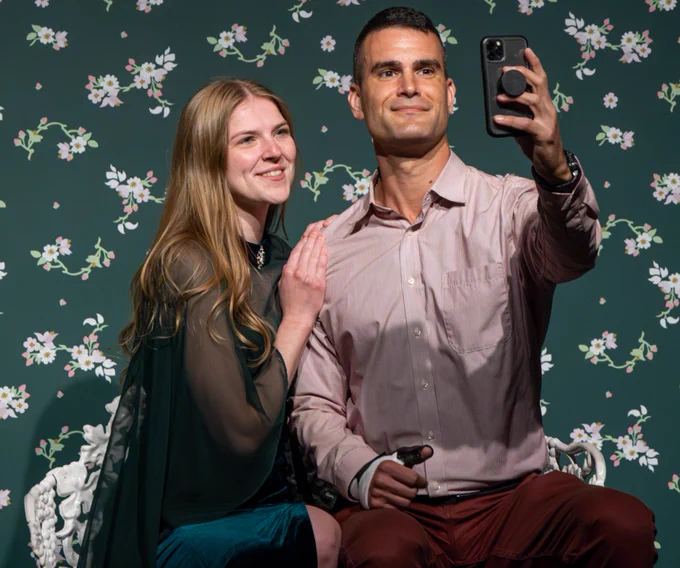 A couple takes a selfie in a selfie station within VMFA's special exhibition "Frida: Beyond the Myth."