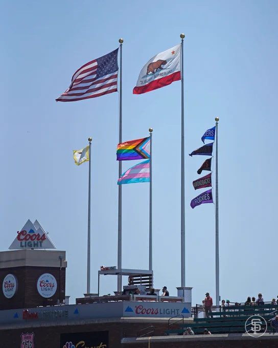 A Progress Pride Flag and a Transgender Flag flying over Oracle Park
