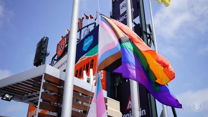 Close up of the Progress Pride Flag being raised.
