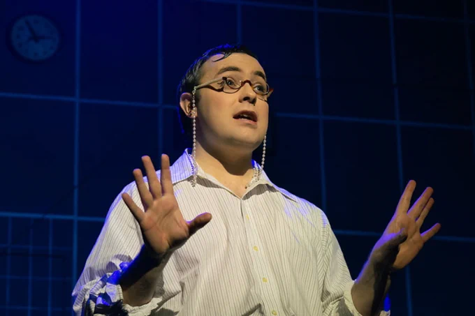 A photo showing a performer gesturing 