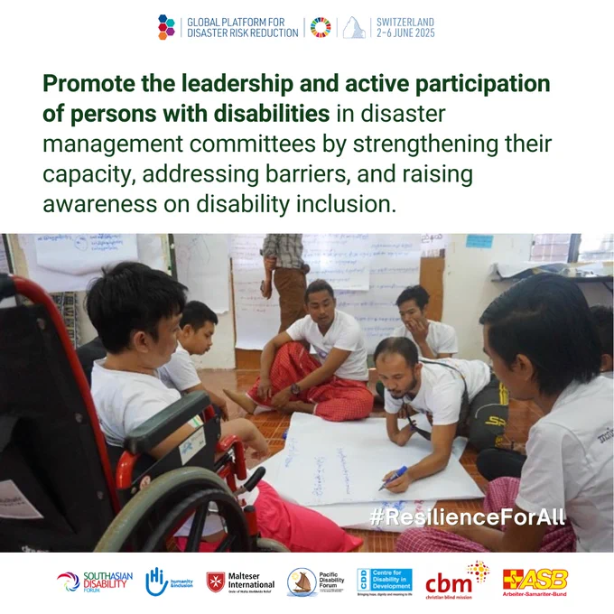 A photo of a group of people, including a person using a wheelchair, collaborate on a project, writing on large sheets of paper during a disaster management committee meeting. And message about promoting leadership and active participation of persons with disabilities. 