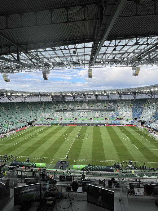 View from the west side of Stadion Wroclaw. It’s a one tired bowl shaped stadium with green seats.
