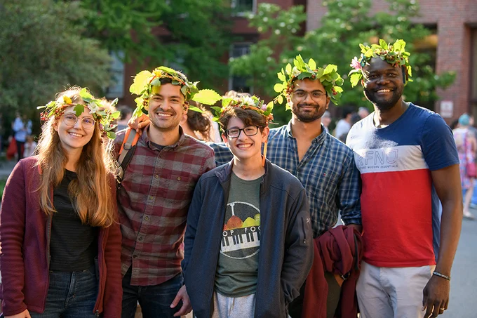 Group of young people wearing flower crowns and smiling in an outside setting. Photo ⓒ Tony Rinaldo.
