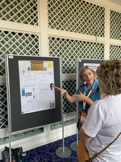 Dereca pictured beside poster on ‘simplifying library labyrinth for students with Intellectual disabilities.