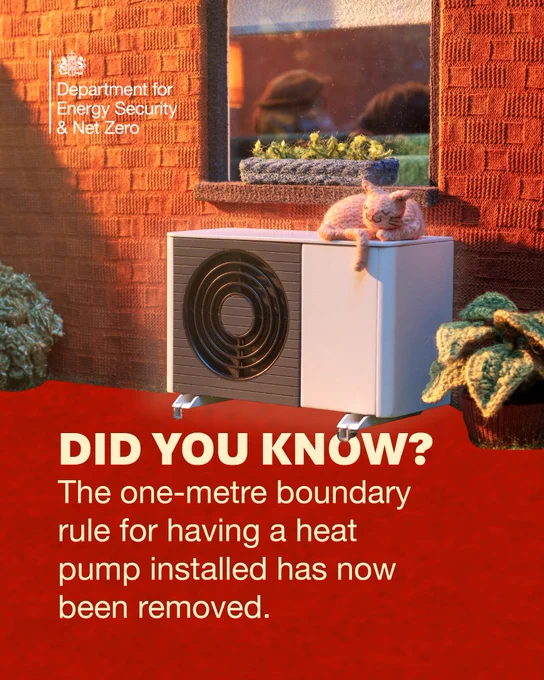 Image from the Department for Energy Security & Net Zero featuring a cat resting on a heat pump outside a brick house, with text overlay reading: 'DID YOU KNOW? The one-metre boundary rule for having a heat pump installed has now been removed.'