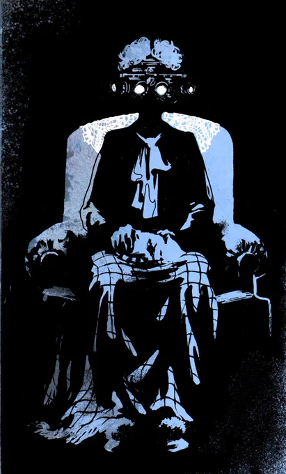 An image of an elderly woman (presumably) sitting comfortably in her chair with a blanket over her lower half and a device on her face resembling a bulky VR headset.