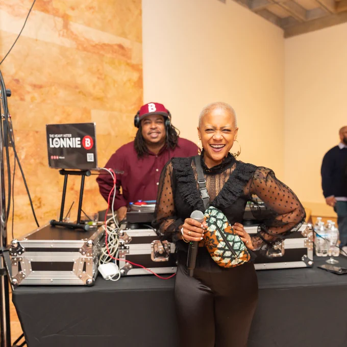 A shot of Kelli Lemon and DJ Lonnie B standing at a DJ setup during an Art After Hours event at VMFA.