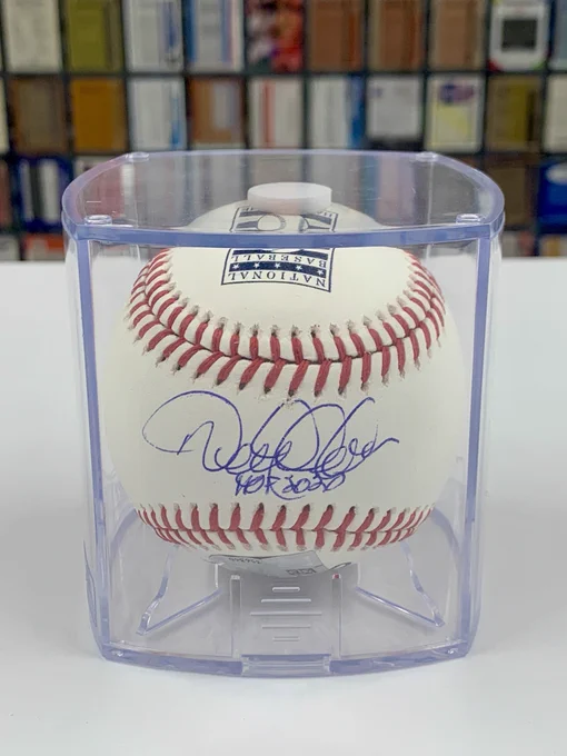 A Derek Jeter autographed baseball in a clear case.
