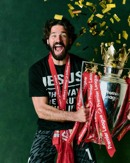 Backdrop photography of Alisson Becker with the Premier League trophy.